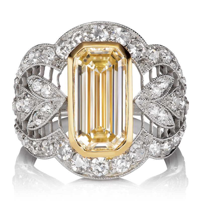 Intricate Edwardian Platinum Filigree Ring with a Warm Emerald Cut Diamond