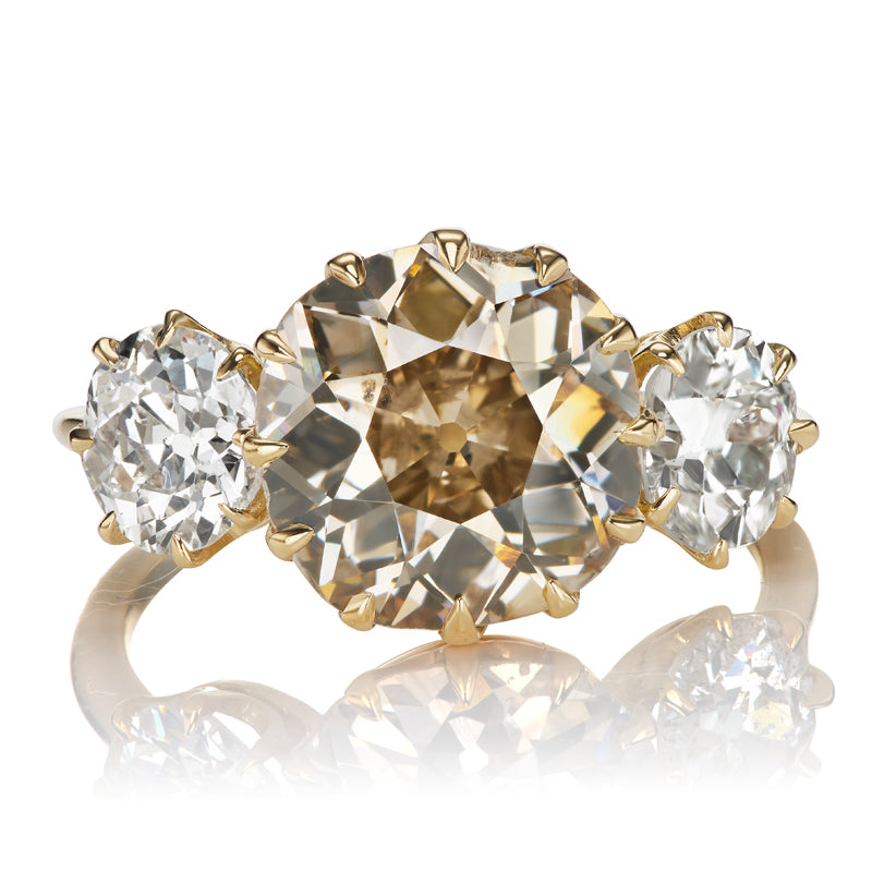 Three Stone Ring Centering a 3.5 Carat Old Mine Cut Diamond of Champagne Color