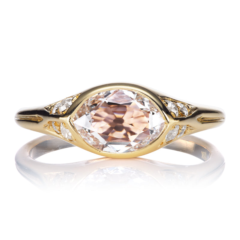 Unique Gold Bezel Set Marquise Cut Diamond Ring with Pink Hues