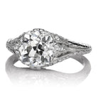 Amma 2.78 features a vintage-style silver ring with an intricate design and a large round sparkling center stone.