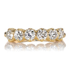 The Felicia 1.31 gold ring showcases a row of six round, sparkling white diamonds in prong settings, displayed on a white background with a subtle reflection underneath.