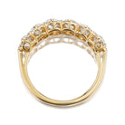 The PENDING Felicia 1.31 is a gold ring with a curved band, showcasing round-cut white gemstones in a prong setting along the top, seen from the underside.